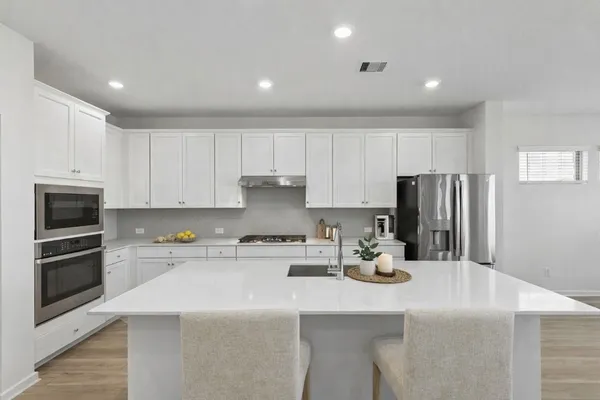 a kitchen with a sink a stove and refrigerator