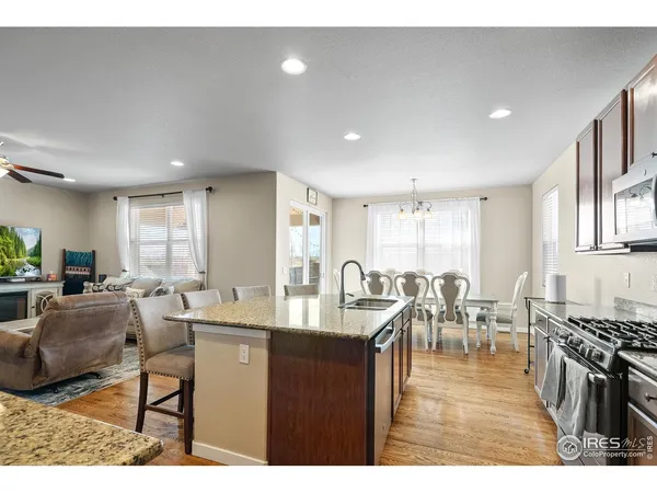 a living room with lots of furniture and kitchen view