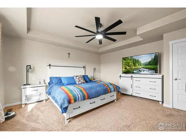 a living room with a bed and flat screen tv
