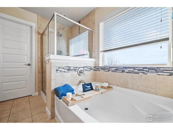 a bathroom with a sink a mirror and tub