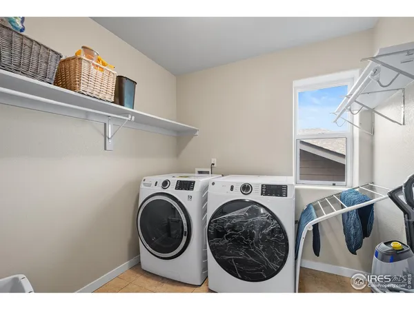 a view of washer and dryer with kitchen in the background