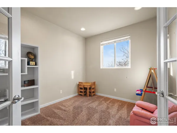 a hallway with a window and a wooden floor