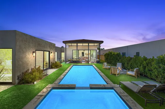 a view of a house with a patio and a yard