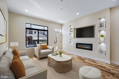 a living room with furniture a fireplace and a flat screen tv