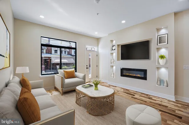 a living room with furniture a fireplace and a flat screen tv
