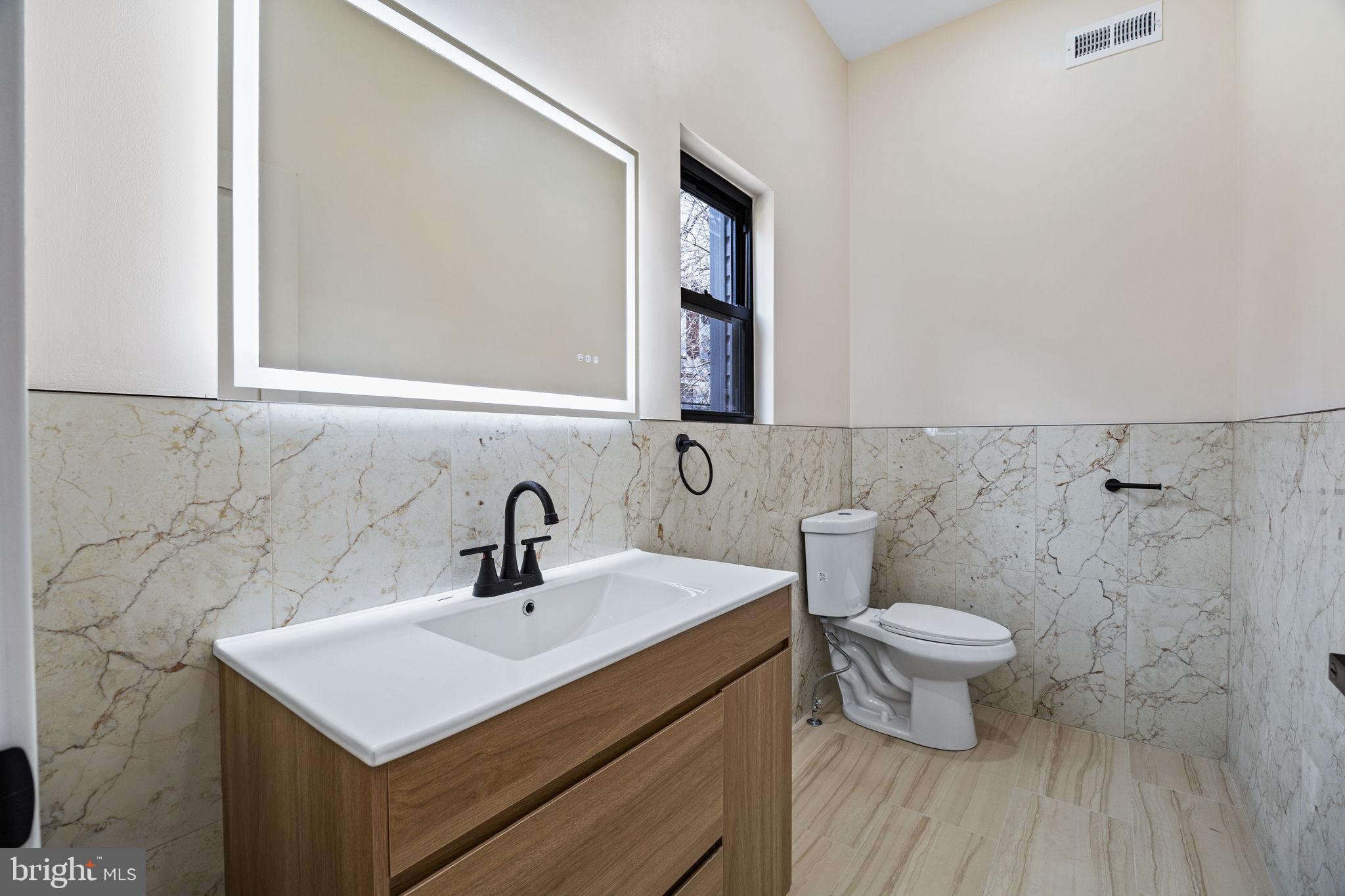 272 South Frazier Street Philadelphia, PA 19139 - Photo 11 of 34 a bathroom with a sink toilet a mirror and shower