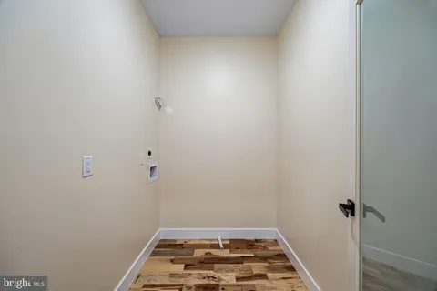 a view of a big room with wooden floor and a ceiling fan