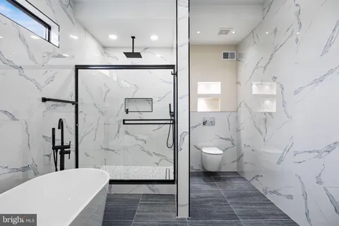 a bathroom with a bathtub and a double vanity sink
