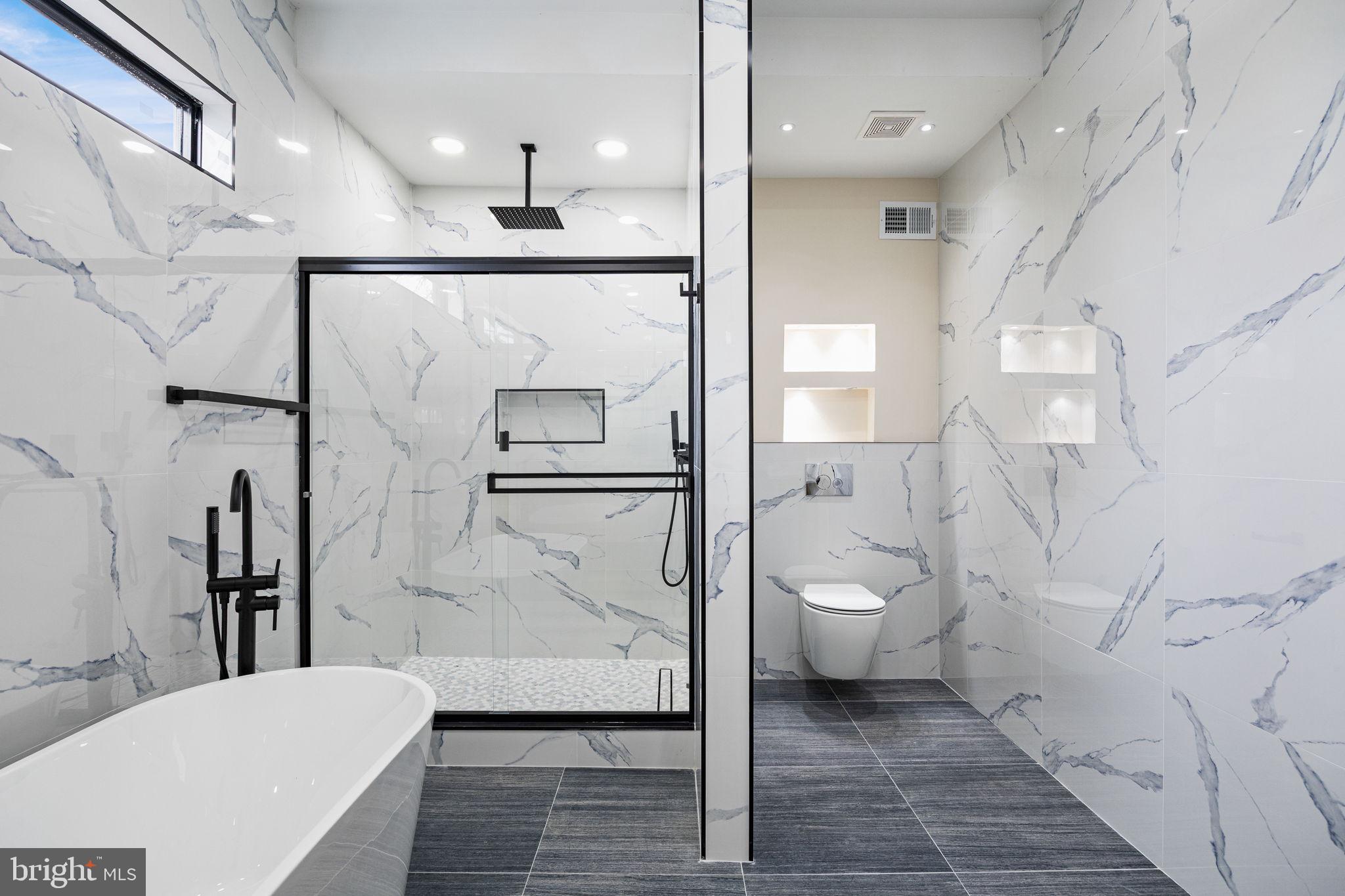 272 South Frazier Street Philadelphia, PA 19139 - Photo 24 of 34 a bathroom with a granite countertop toilet sink and shower
