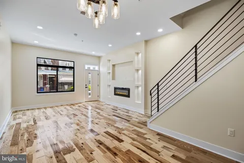 a kitchen with stainless steel appliances granite countertop a sink a stove and a wooden cabinets