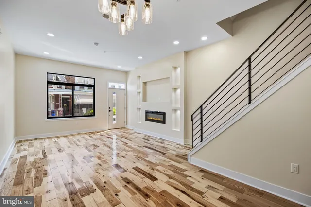 a kitchen with stainless steel appliances granite countertop a sink a stove and a wooden cabinets