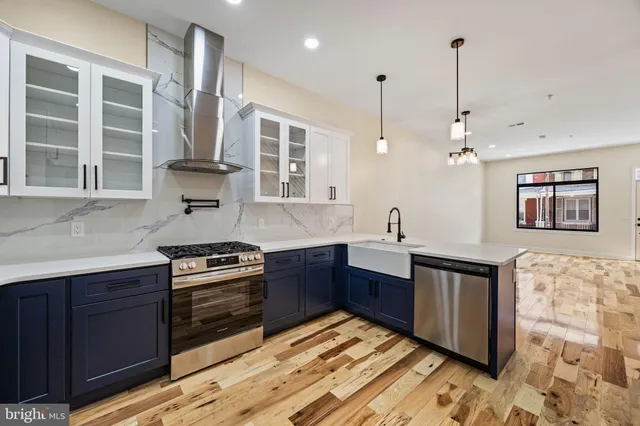 a kitchen with kitchen island wooden cabinets and stainless steel appliances