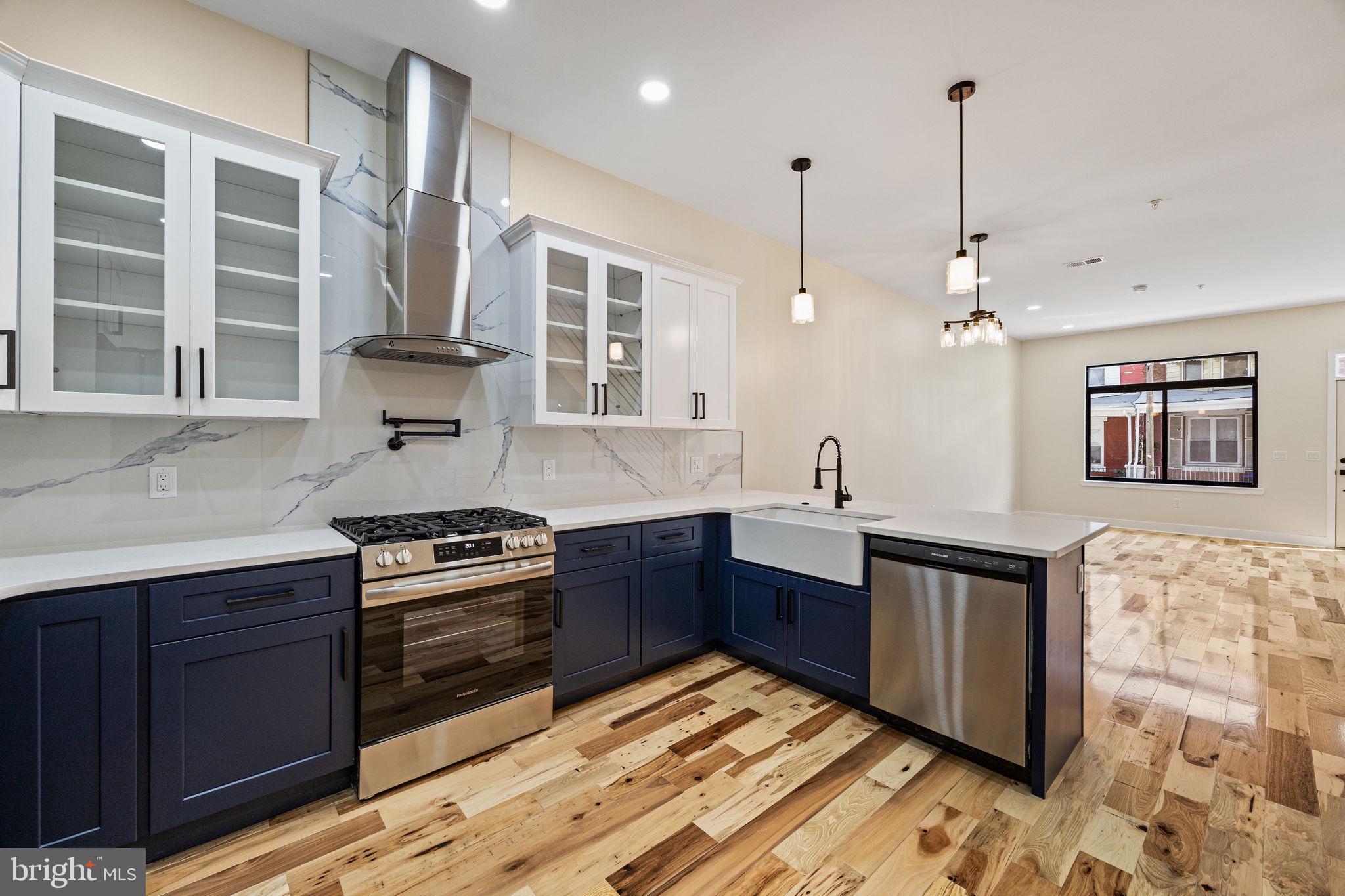 272 South Frazier Street Philadelphia, PA 19139 - Photo 7 of 34 a kitchen with stainless steel appliances granite countertop a sink a stove and a wooden cabinets