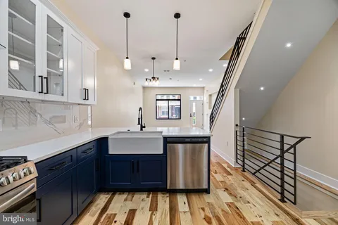 a kitchen with stainless steel appliances granite countertop a stove and a cabinets