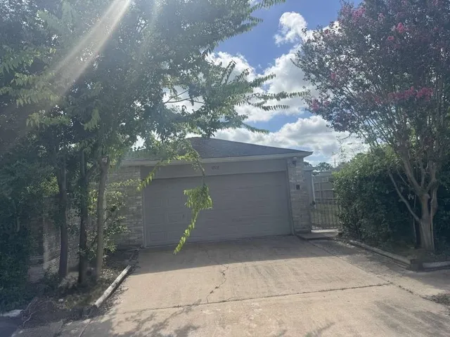 a view of a house with a yard and garage