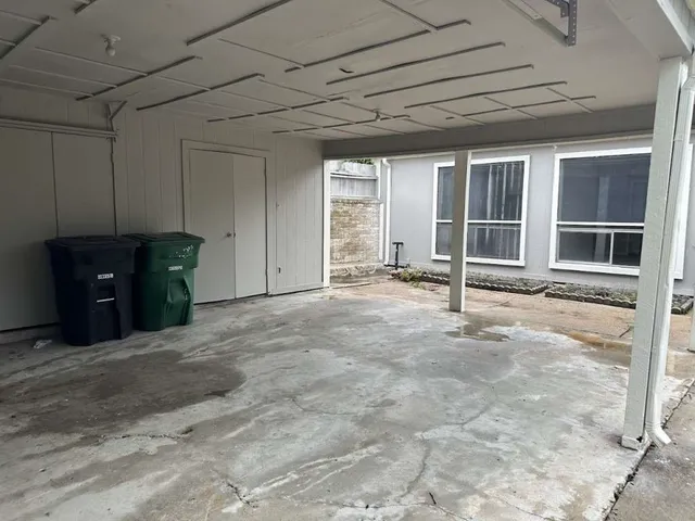 a view of an empty room with cabinet and a window