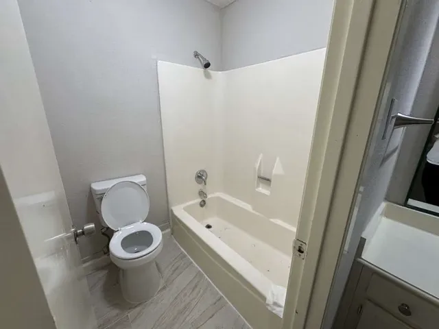 a white toilet sitting next to a bathroom sink
