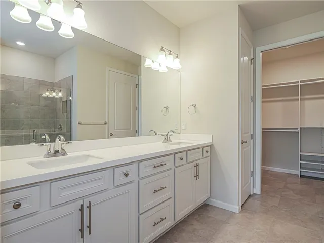 a bathroom with double vanity sink and a mirror