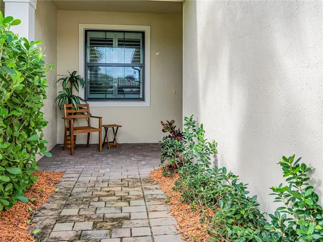 a bench in a yard with potted plants