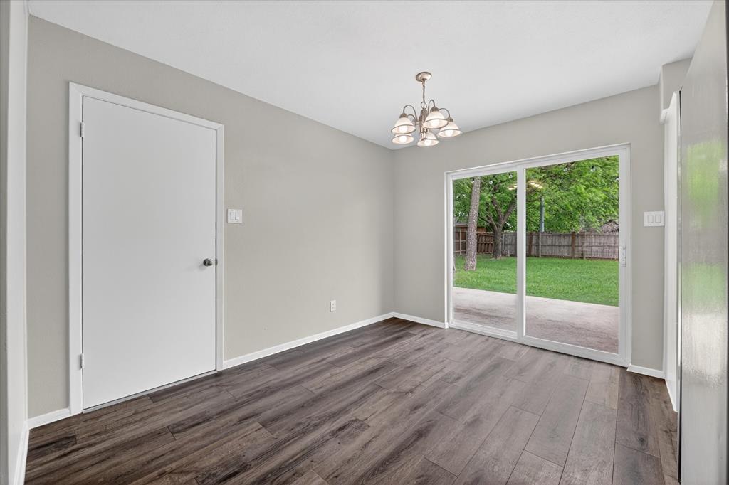 205 Wayne Street Sanger, TX 76266 - Photo 13 of 29 a view of an empty room with wooden floor and a window