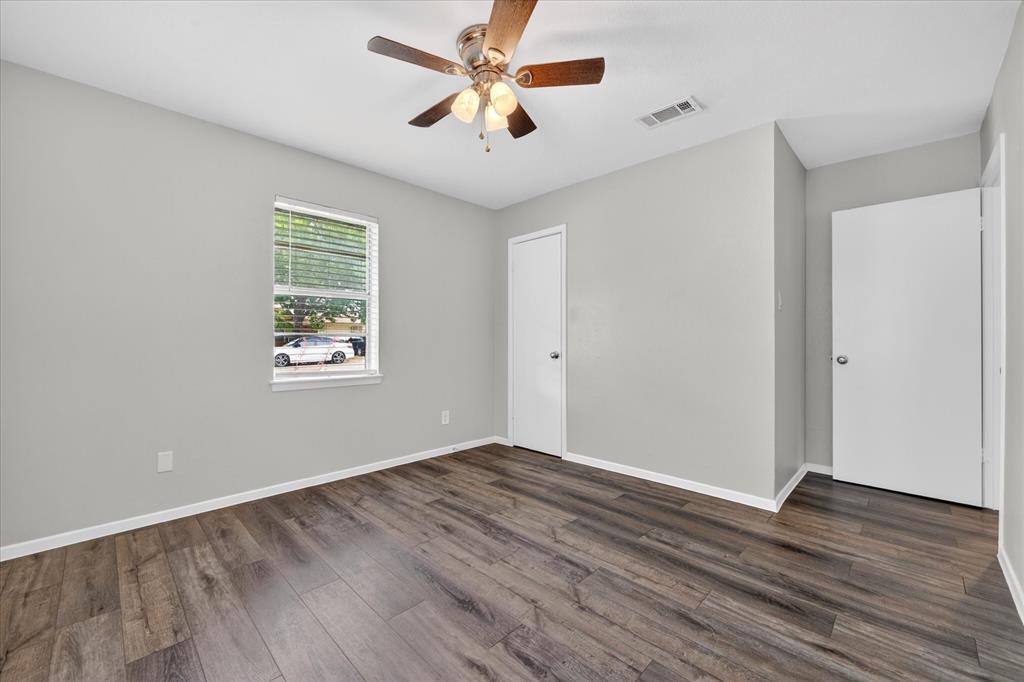 205 Wayne Street Sanger, TX 76266 - Photo 17 of 29 an empty room with wooden floor and windows