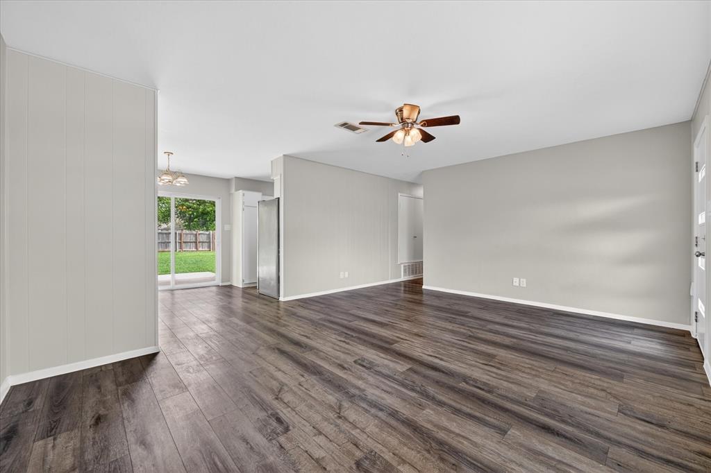 205 Wayne Street Sanger, TX 76266 - Photo 2 of 29 a view of an empty room with a window and wooden floor