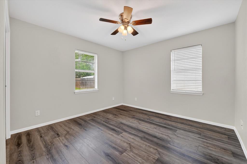205 Wayne Street Sanger, TX 76266 - Photo 22 of 29 a view of empty room with wooden floor and fan