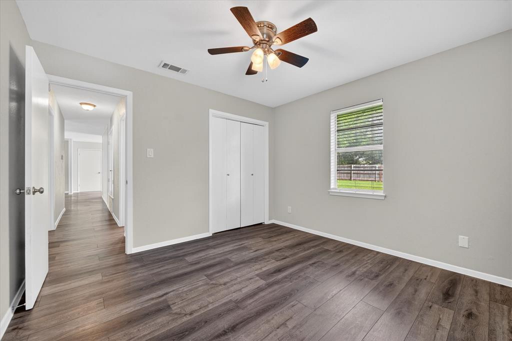 205 Wayne Street Sanger, TX 76266 - Photo 23 of 29 an empty room with wooden floor and windows