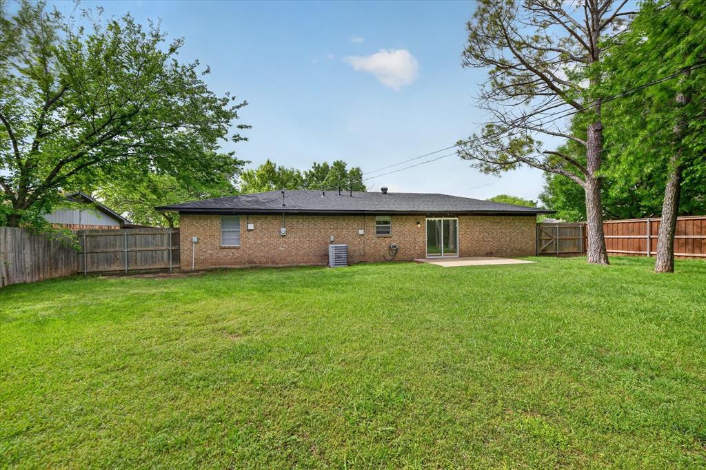 205 Wayne Street Sanger, TX 76266 - Photo 28 of 29 a front view of a house with a garden and yard