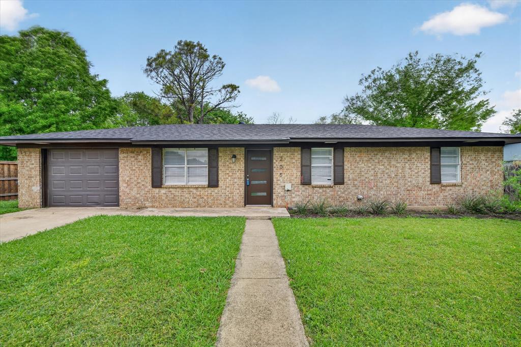 205 Wayne Street Sanger, TX 76266 - Photo 7 of 29 a front view of a house with garden