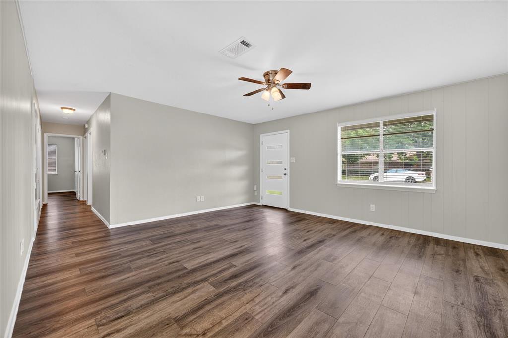 205 Wayne Street Sanger, TX 76266 - Photo 8 of 29 a view of an empty room with a window and wooden floor