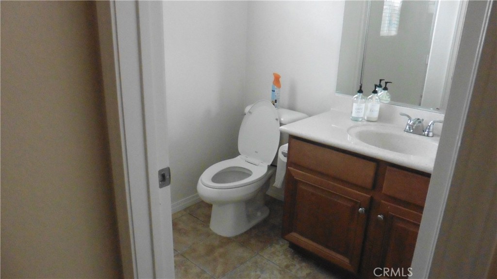 9503 Orleans Lane Riverside, CA 92508 - Photo 12 of 28 a bathroom with a toilet sink and mirror