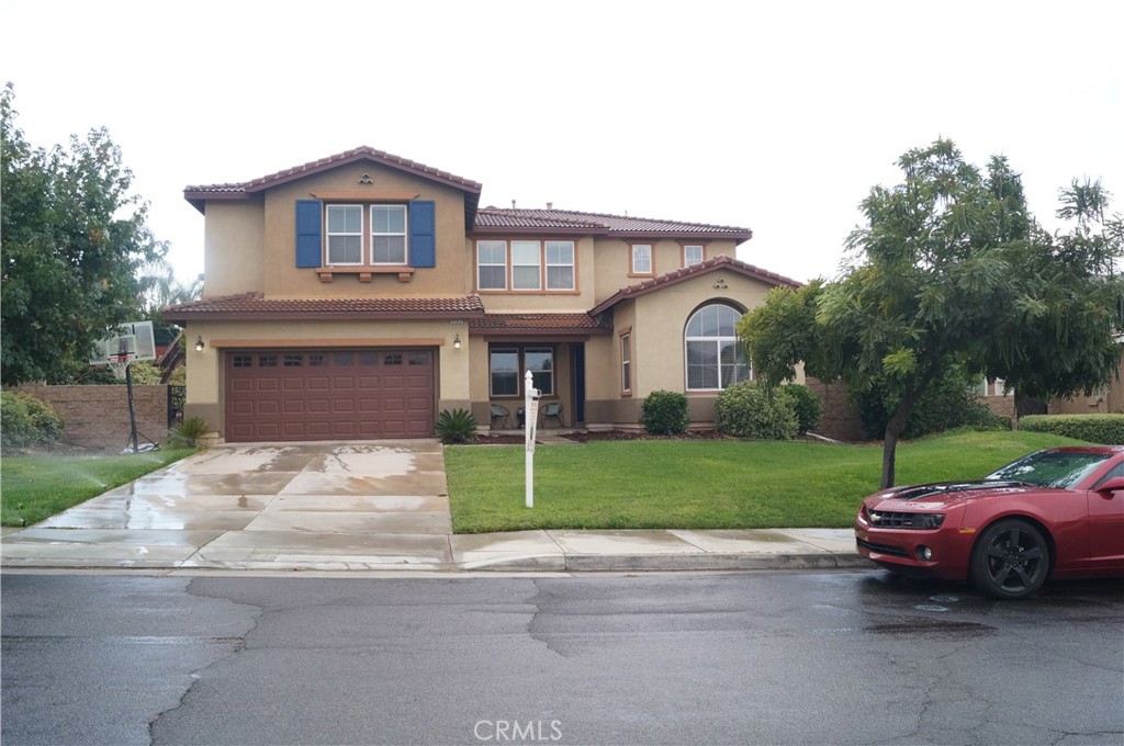 9503 Orleans Lane Riverside, CA 92508 - Photo 2 of 28 a front view of a house with a garden and parking