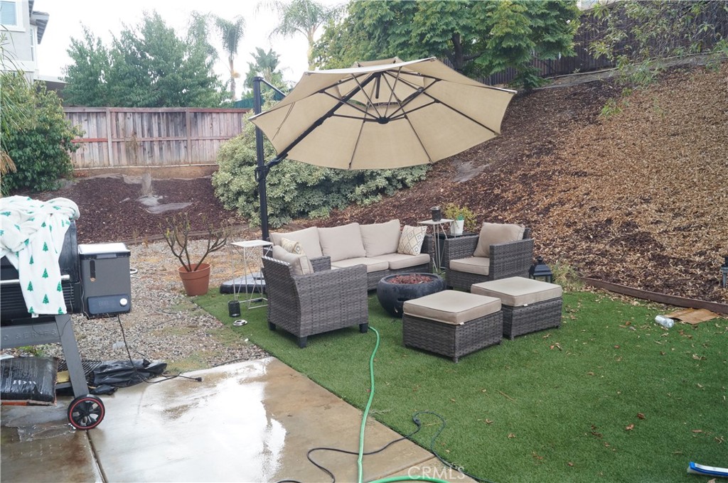 9503 Orleans Lane Riverside, CA 92508 - Photo 25 of 28 a view of a patio with couches under an umbrella