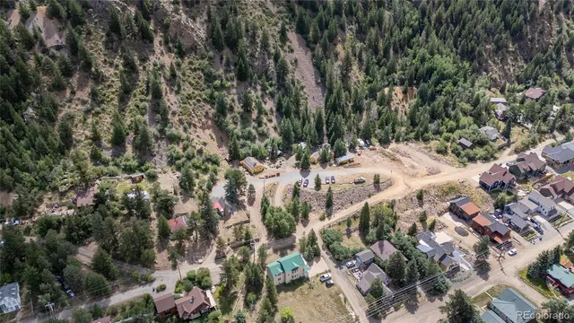 a view of a city with lush green forest