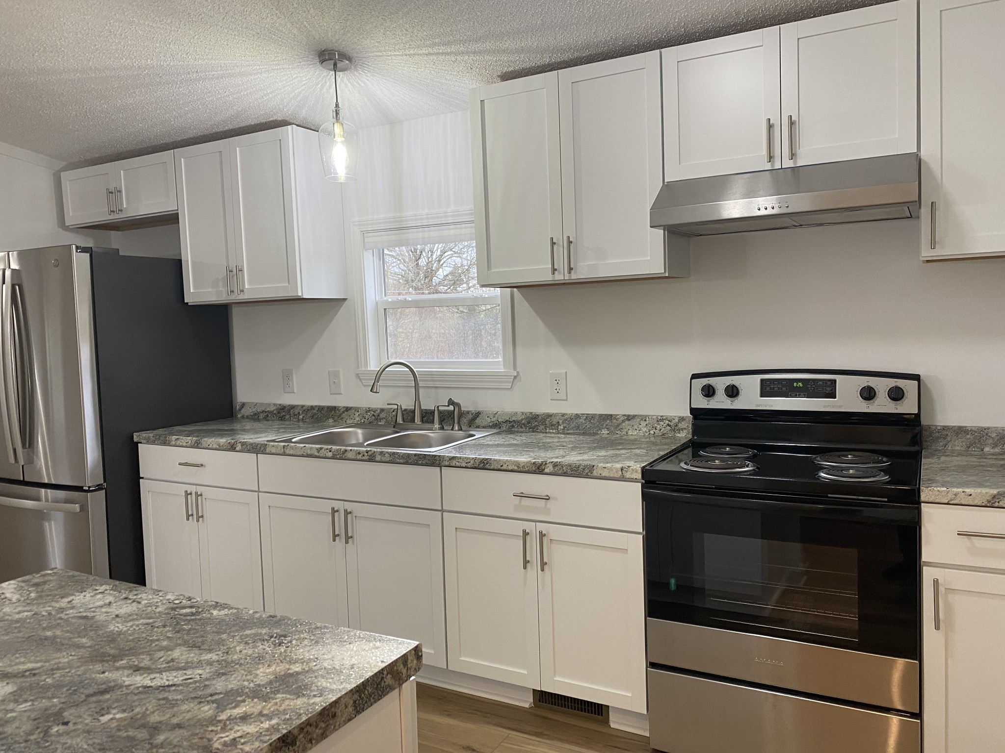 404 B Dorris Road, Unit B Portland, TN 37148 - Photo 4 of 24 a kitchen with granite countertop white cabinets and stainless steel appliances