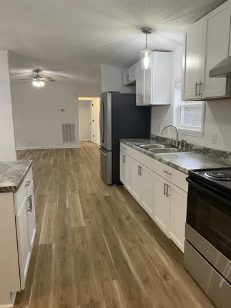 a kitchen with a sink stove and refrigerator