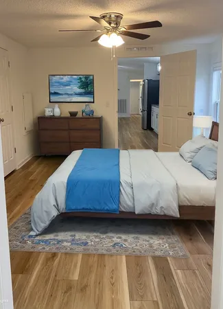 a bedroom with a bed and dresser