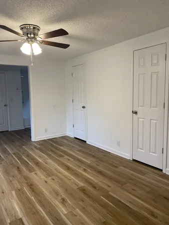 a view of empty room with wooden floor
