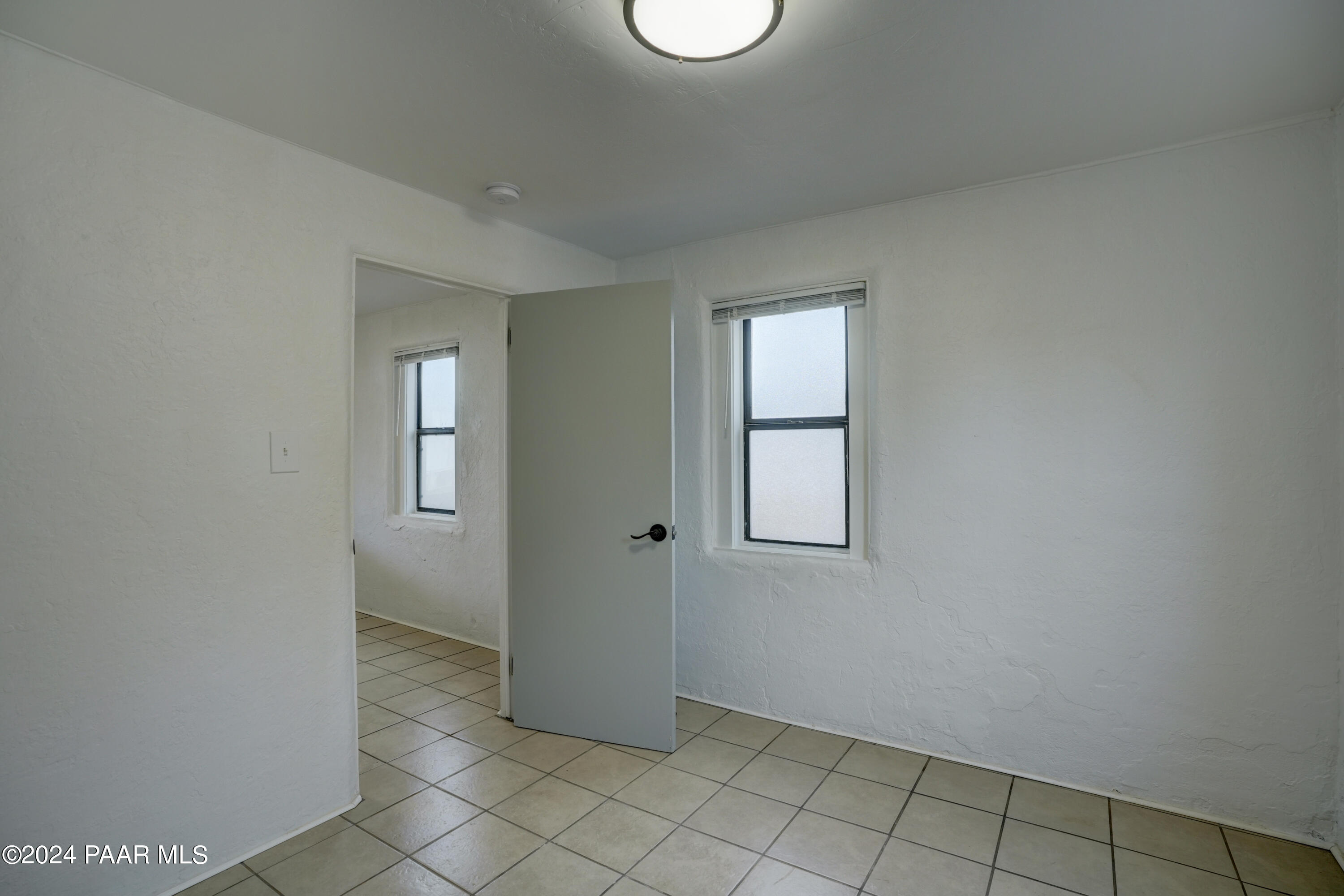 925 Ruth Street, Unit B Prescott, AZ 86301 - Photo 12 of 15 an empty room with windows