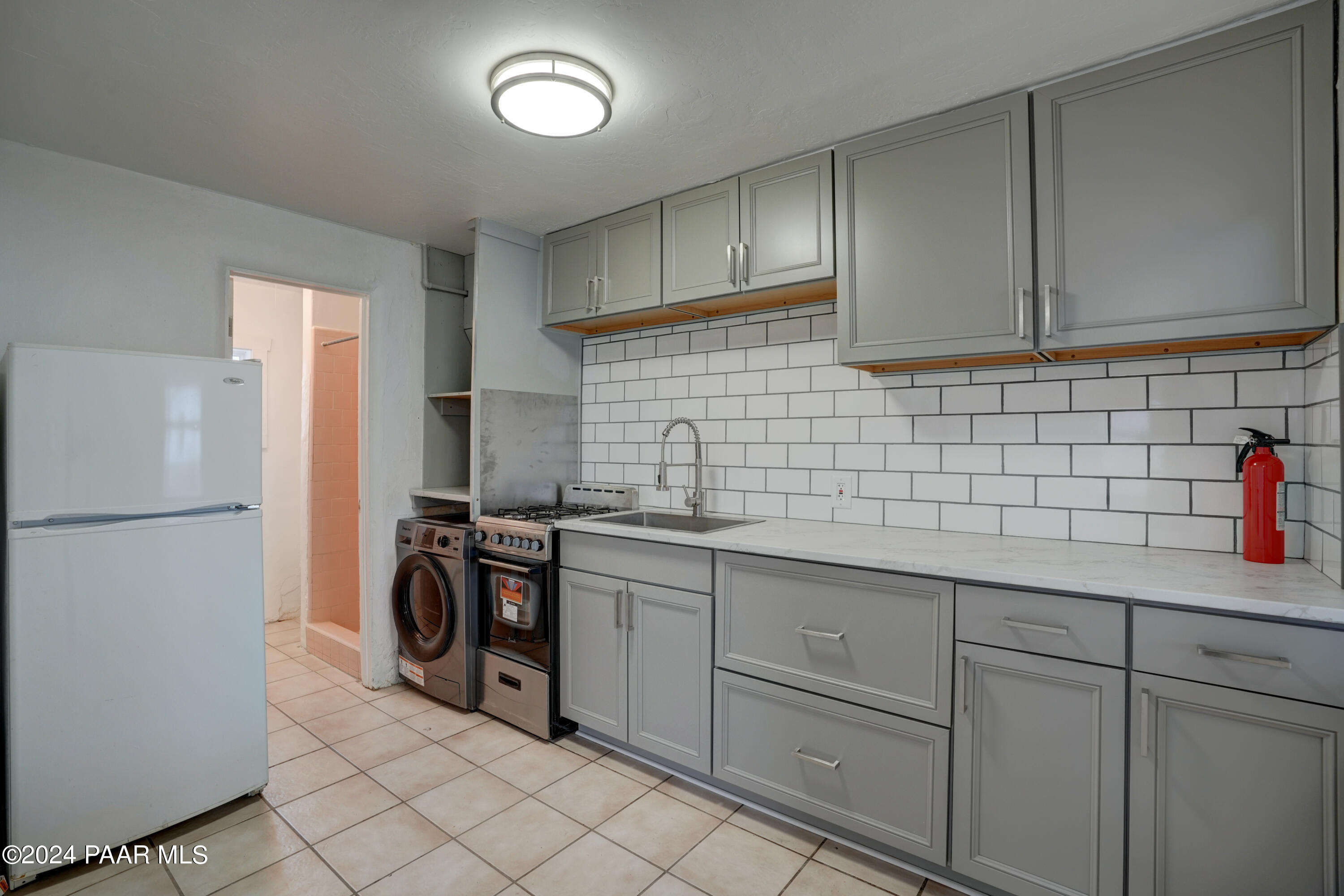 925 Ruth Street, Unit B Prescott, AZ 86301 - Photo 7 of 15 a kitchen with a sink a refrigerator and cabinets