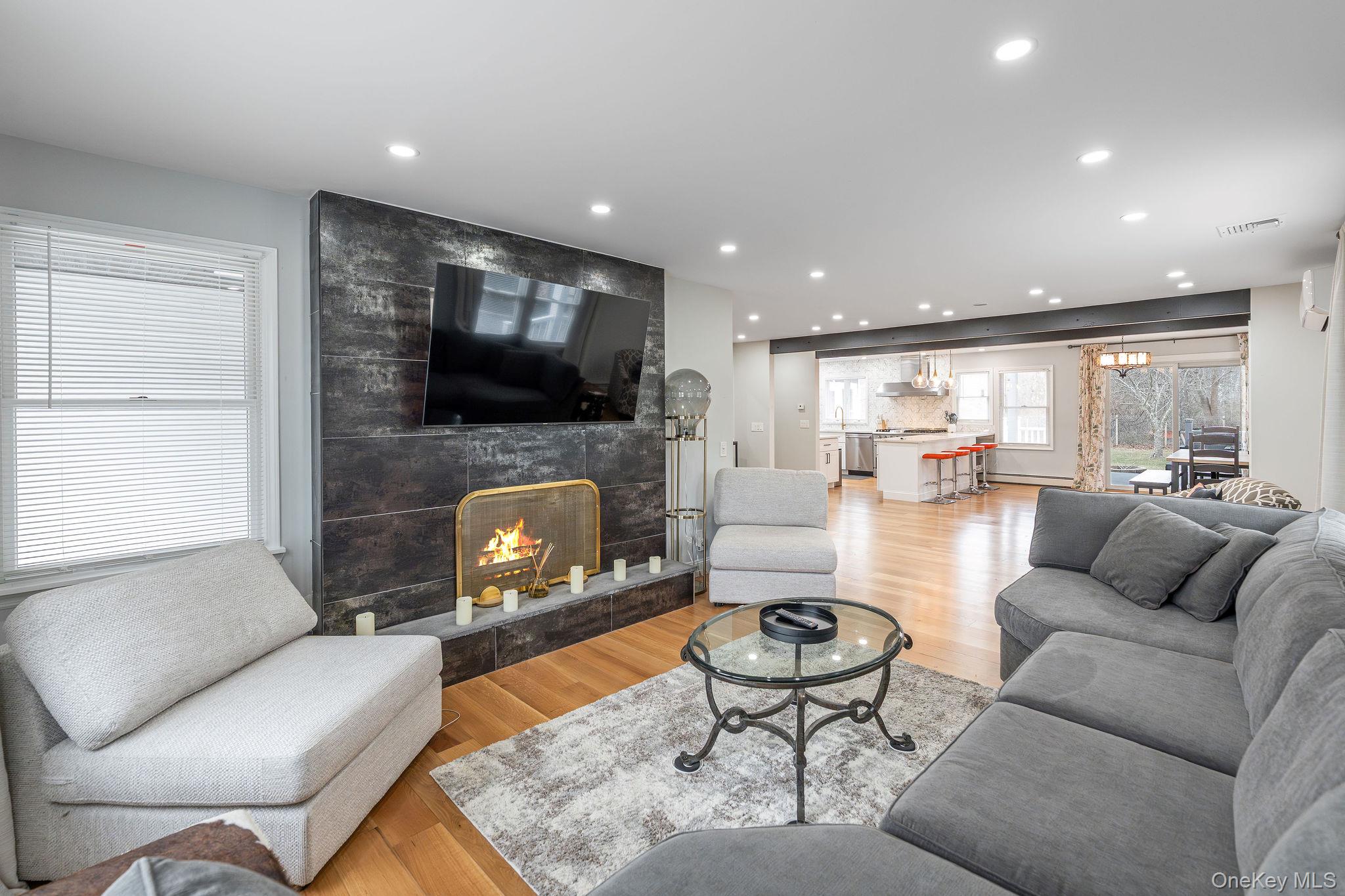 10940 Main Road East Marion, NY 11939 - Photo 12 of 38 a living room with furniture and a fireplace