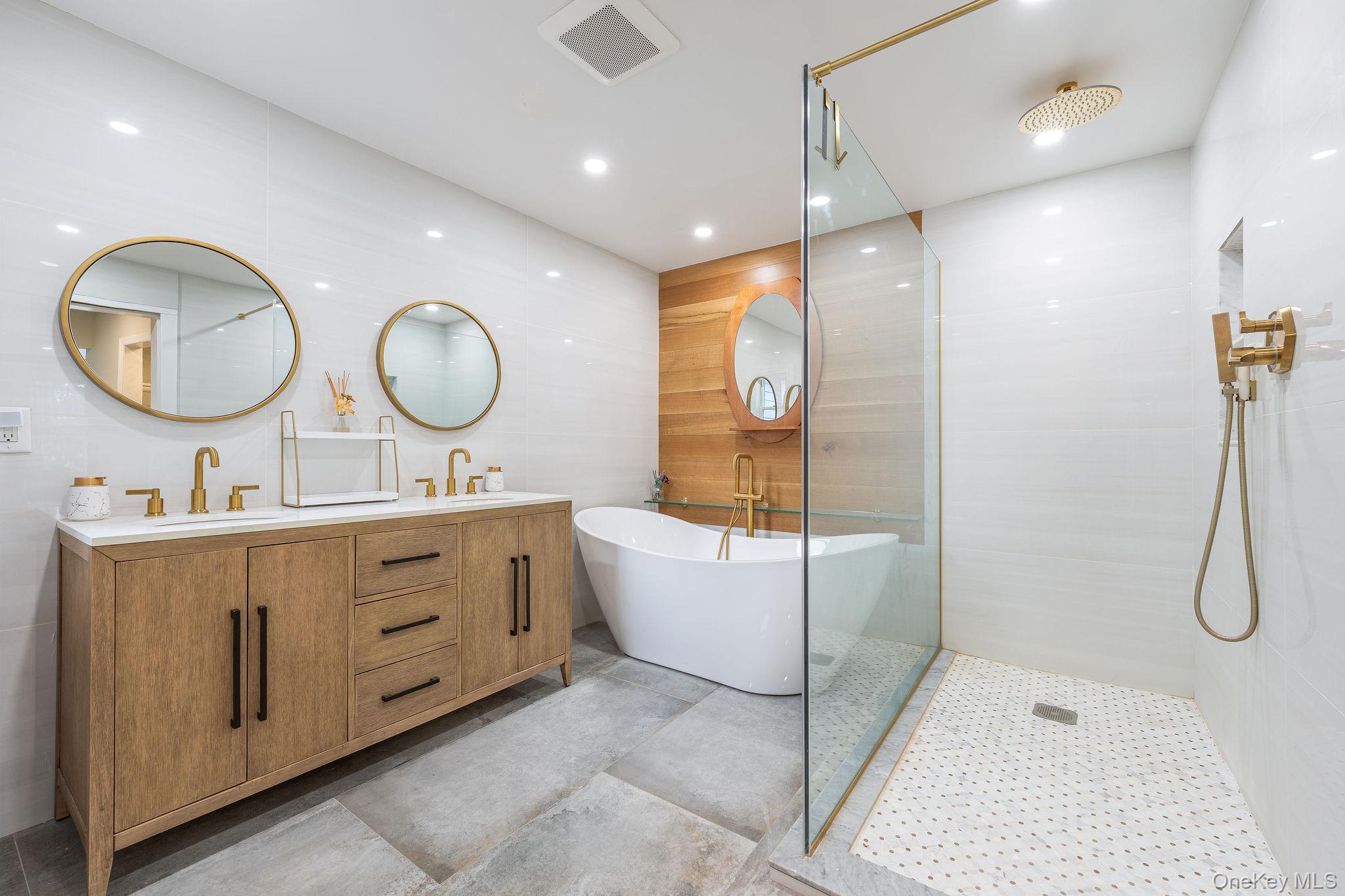 10940 Main Road East Marion, NY 11939 - Photo 16 of 38 a bathroom with a double vanity sink mirror and shower
