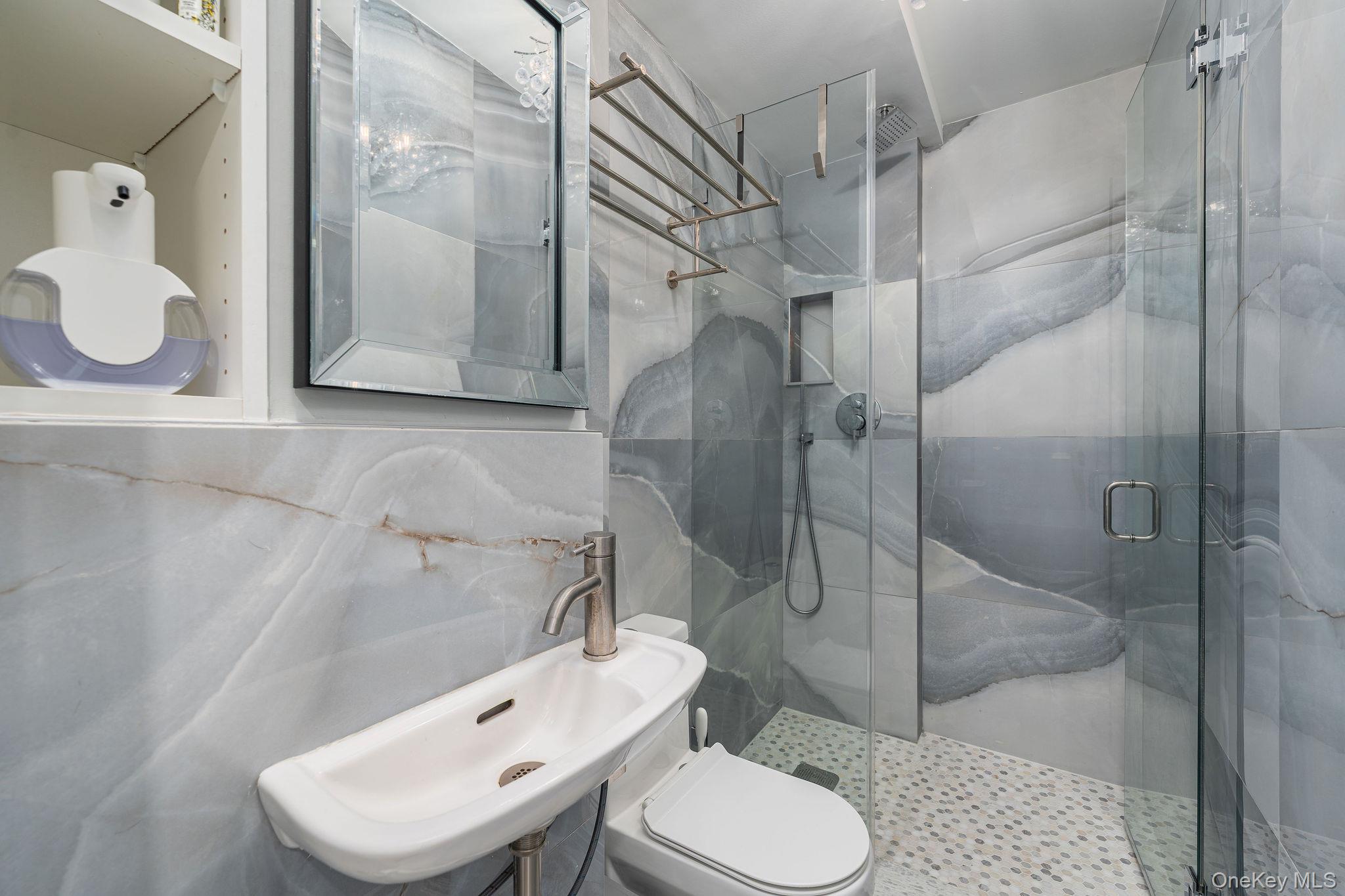 10940 Main Road East Marion, NY 11939 - Photo 18 of 38 a bathroom with a toilet sink and shower