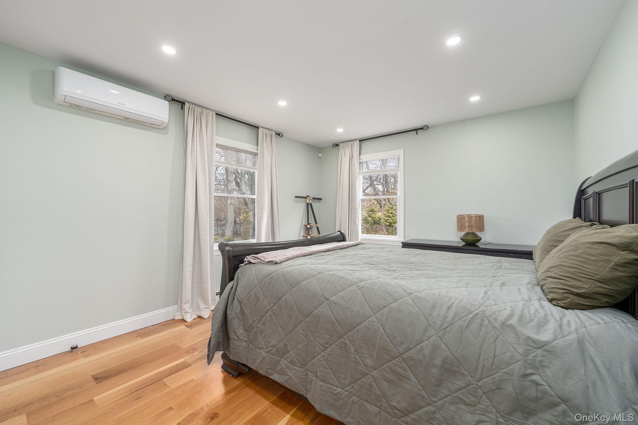 10940 Main Road East Marion, NY 11939 - Photo 19 of 38 a bedroom with a large bed and wooden floor
