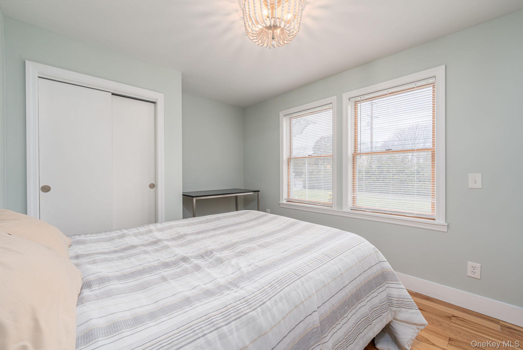 10940 Main Road East Marion, NY 11939 - Photo 20 of 38 a bedroom with a bed and a window