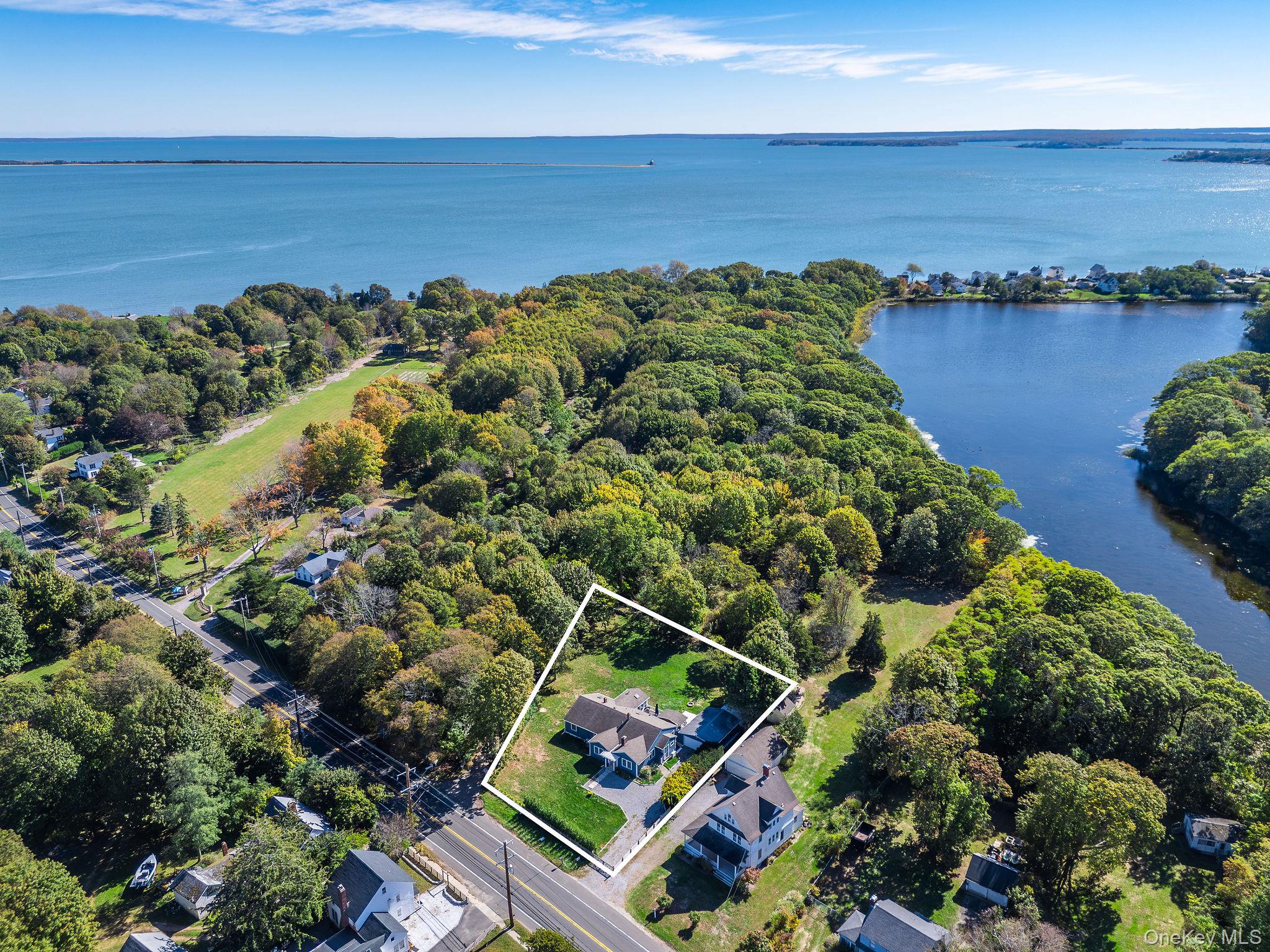 10940 Main Road East Marion, NY 11939 - Photo 2 of 38 a aerial view of a house with a yard and lake view