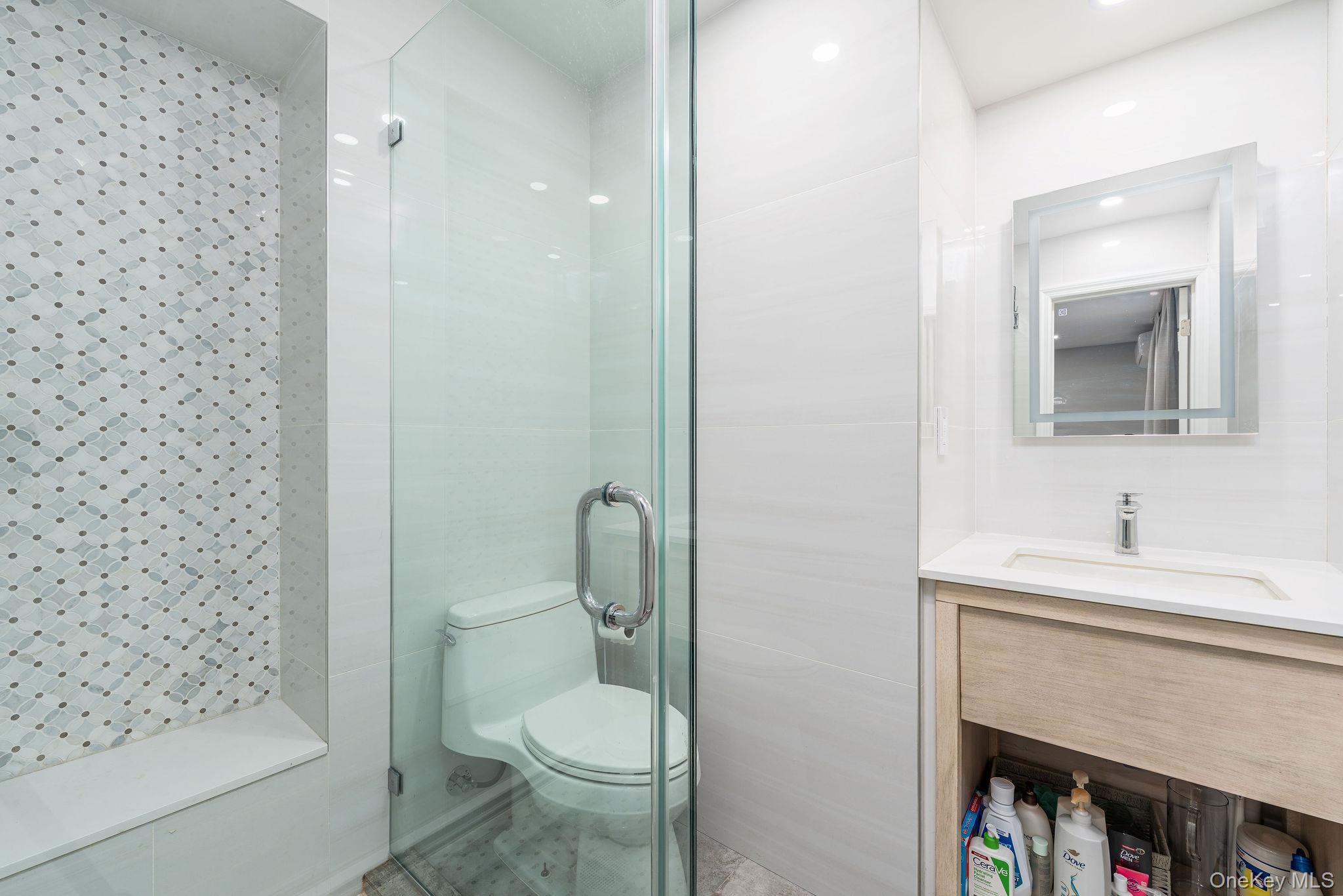 10940 Main Road East Marion, NY 11939 - Photo 21 of 38 a bathroom with a toilet a sink and mirror