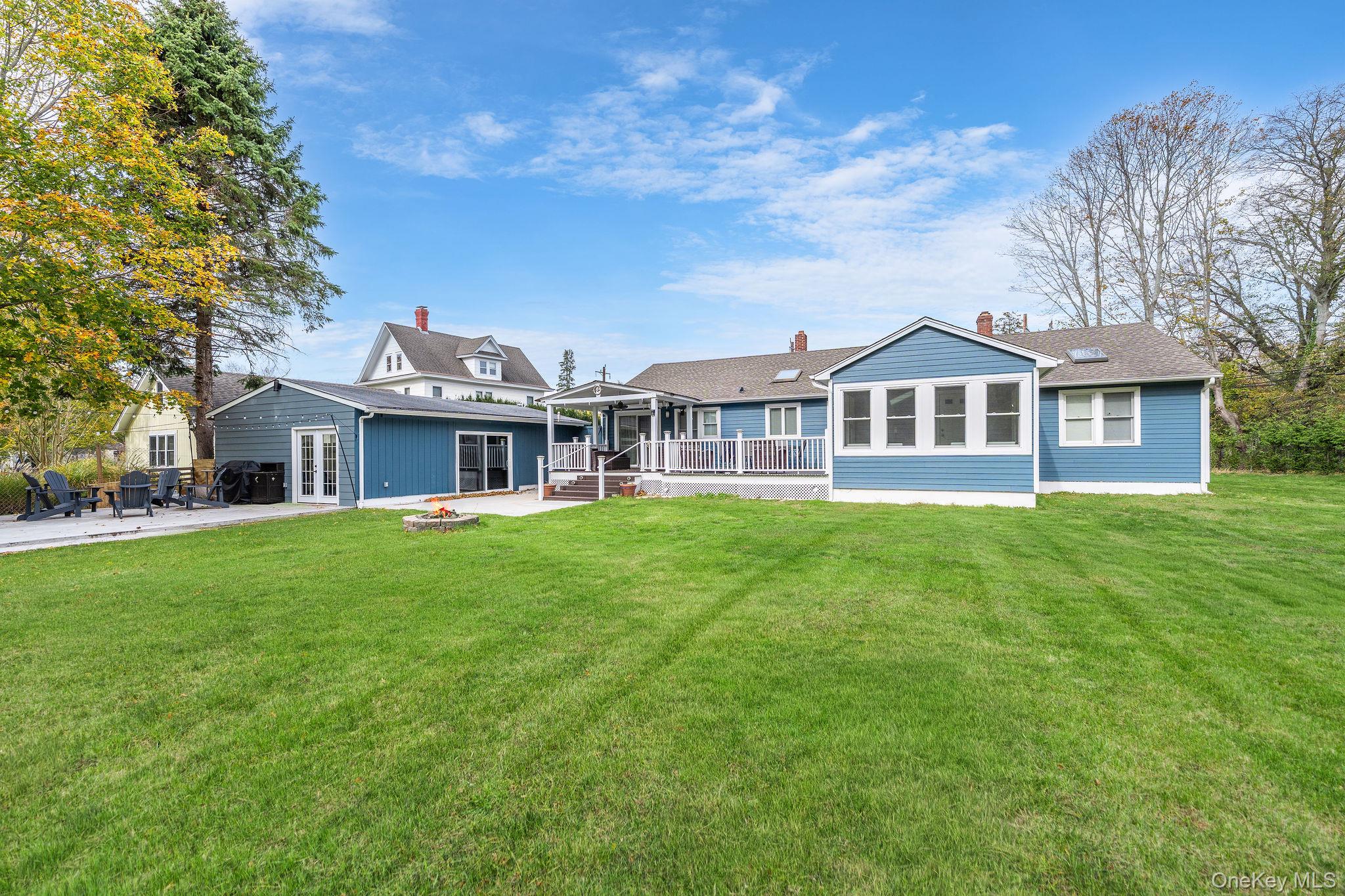 10940 Main Road East Marion, NY 11939 - Photo 28 of 38 a front view of a house with a garden