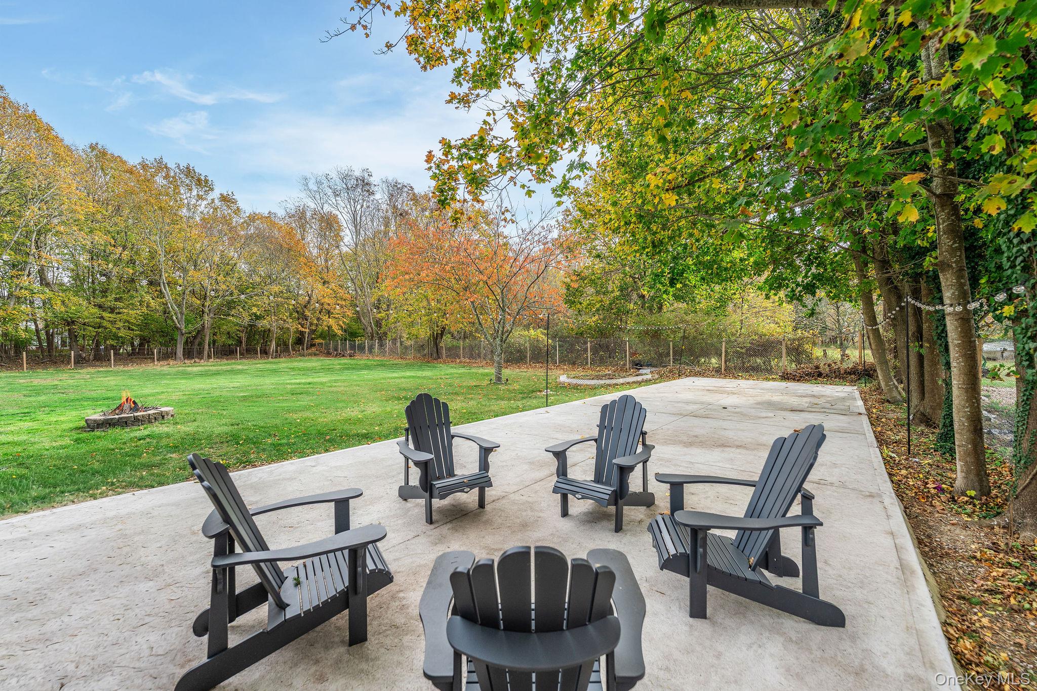 10940 Main Road East Marion, NY 11939 - Photo 30 of 38 a view of a patio with chairs and table in a yard